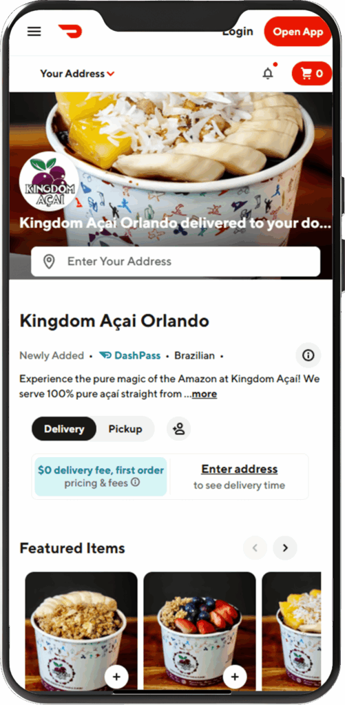 A smartphone screen displays the DoorDash app featuring Kingdom A&ccedil;a&iacute; Orlando, offering delivery and pickup of Brazilian a&ccedil;a&iacute; bowls&mdash;highlighted as some of the best acai in Florida&mdash;with a colorful bowl pictured above menu options.